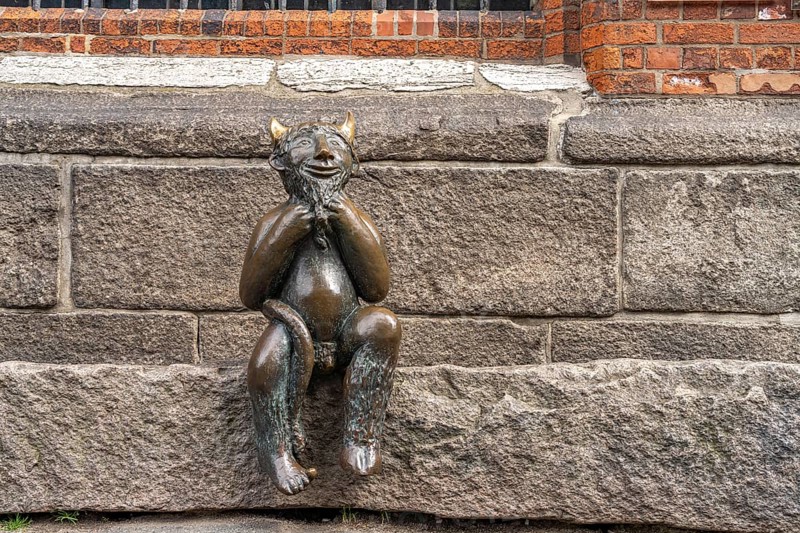 Little Devil bronze sculpture at St Mary's Church, Hanseatic City of Lübeck, Schleswig-Holstein, Germany