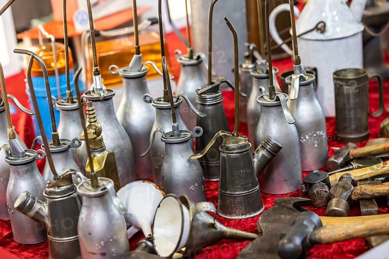 Used oil cans, oil spray cans for lubricating oil for vehicle maintenance. Vintage car trade fair Retro Classics in Stuttgart, Baden-Württemberg, Germany