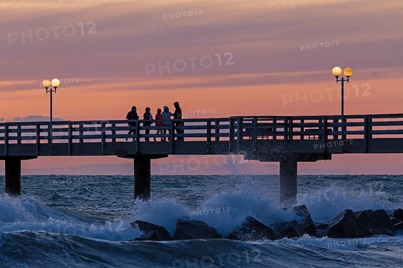 Sunset, pier, people, silhouettes, waves, swell, spray, street lamps, Wustrow, Fischland, Mecklenburg-Vorpommern, Germany