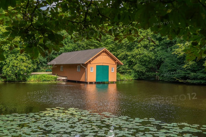 Boathouse at Meiereisee in Bürgerpark from 1866, landscape park with rivers and lakes, garden monument, attraction, recreation, groups of trees, nature, water reflection, water lilies, city state of Bremen, Germany