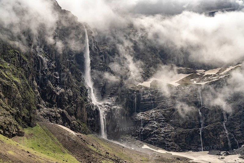Waterfall in the cloudy Cirque de Gavarnie basin, UNESCO World Heritage Site in the Pyrenees National Park near Gavarnie-Gèdre, France