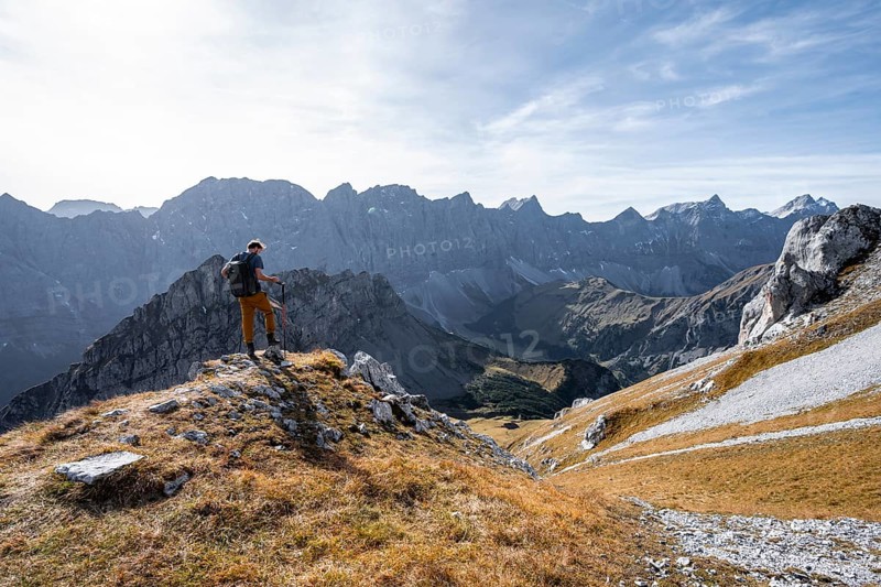 Mountain panorama with picturesque mountain landscape, mountaineers descending from the Gamsjoch, mountain ridge of the Hinterautal-Vomper chain behind, in autumn, Rißtal in the Eng, Karwendel, Tyrol, Austria