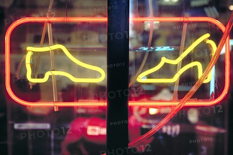 Illuminated advertising in a shoe shop, Manhattan, New York City, USA