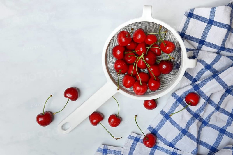 Sweet cherries in sieve, Prunus avium, bird cherry