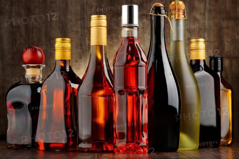 Composition with bottles of assorted alcoholic beverages