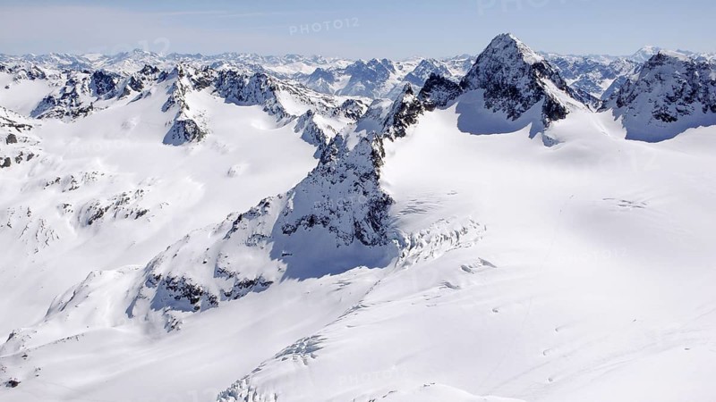 winter mountain landscape in the Silvretta mountain range in the Swiss Alps with famous Piz Buin mountain peak in the center on a beautiful day