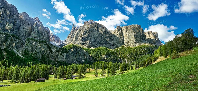 Mountains and pastures of the Sella plateau near Colfosco, 1, 645 m (5) (396 ft), at the foot of the Sella group (Grup dl Sela) and Mount Sassongher, the Dolomite mountains, Alta Badia, Italy