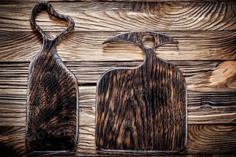 Two dark wood serving and chopping boards