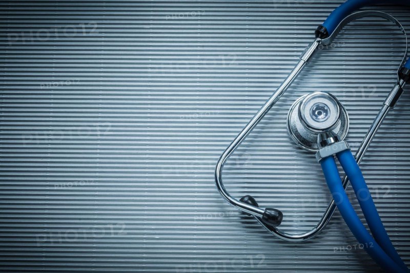 Medical auscultoscope on striped background