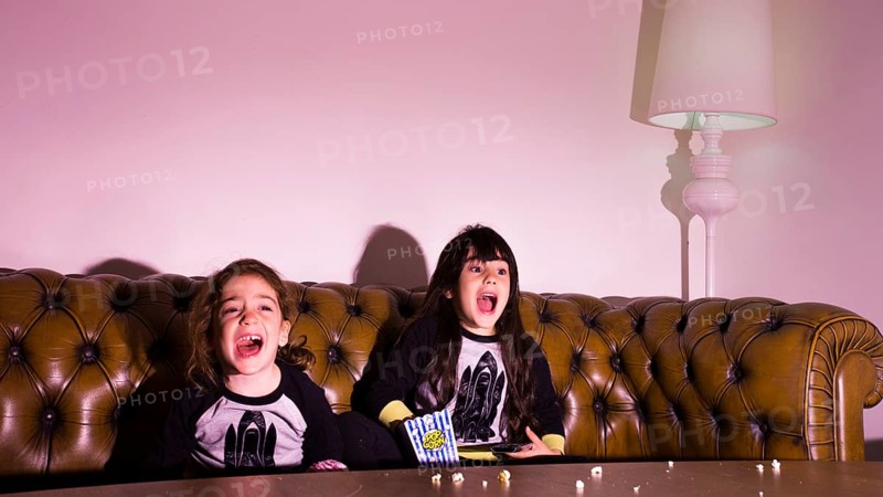 Scared kids watching movie home