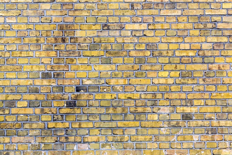Old yellow brick wall for backgrounds