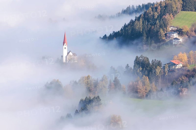 The Church of St. Peter in the fog, Weerberg, Tyrol, Austria