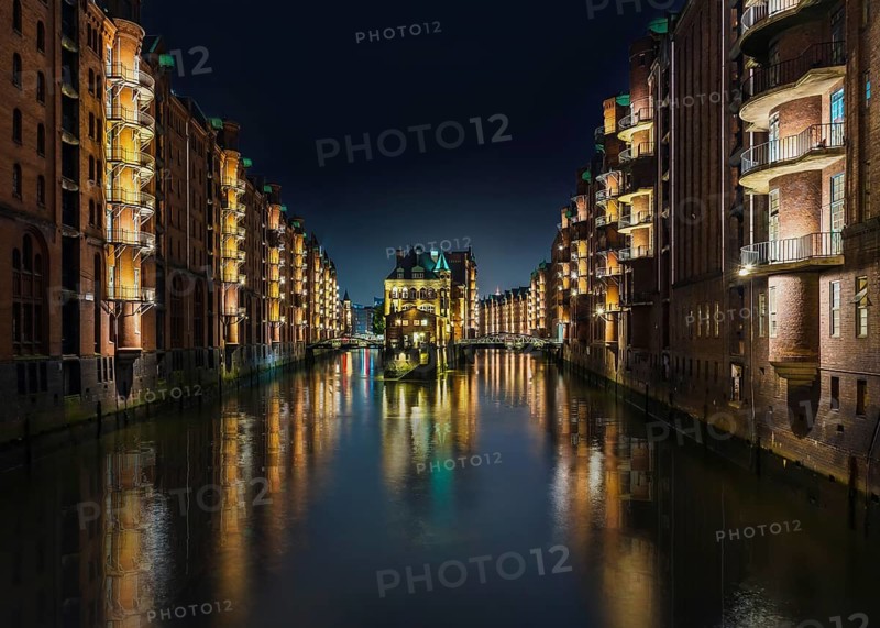 long exposure shot of canal in old warehouse district Speicherstadt in Hamburg, Germany at night