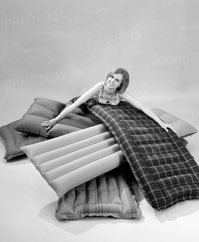 1960s. A young woman wearing a bikini, in a photographers studio with different types and brands of air mattresses. A picture taken to illustrate the new ones available in different shapes and colors to use the upcoming summer. Sweden 1967. Conard ref 5447