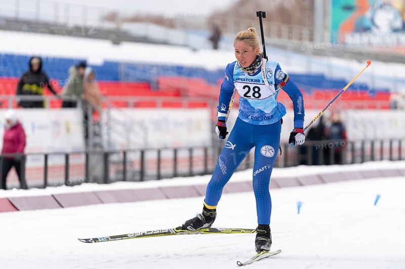 Sportswoman biathlete Petrunova Kseniya Kamchatka Region skiing on distance biathlon stadium. Open regional youth biathlon competitions East Cup. Kamchatka Peninsula, Russian Far East, Apr 12, 2019