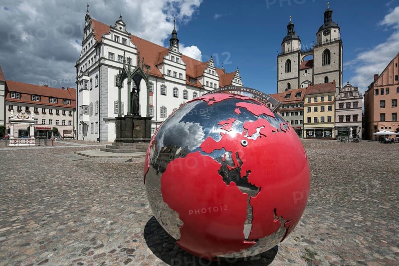 Luther city Wittenberg market square 6361 left town hall 16th century in front monument to Melanchton right towers of the town church 13th-16th century in front Reformation anniversary globe
