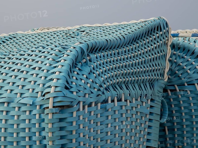 Close-up of a turquoise-coloured wicker beach chair, egmond, north sea, netherlands
