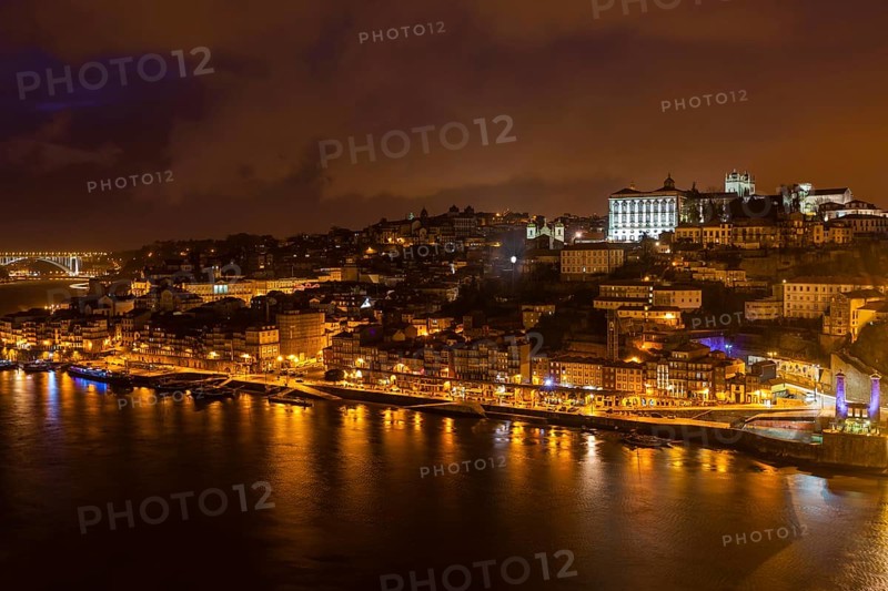 Overview of Old Town of Porto, Portugal at night. Ribeira and Douro river