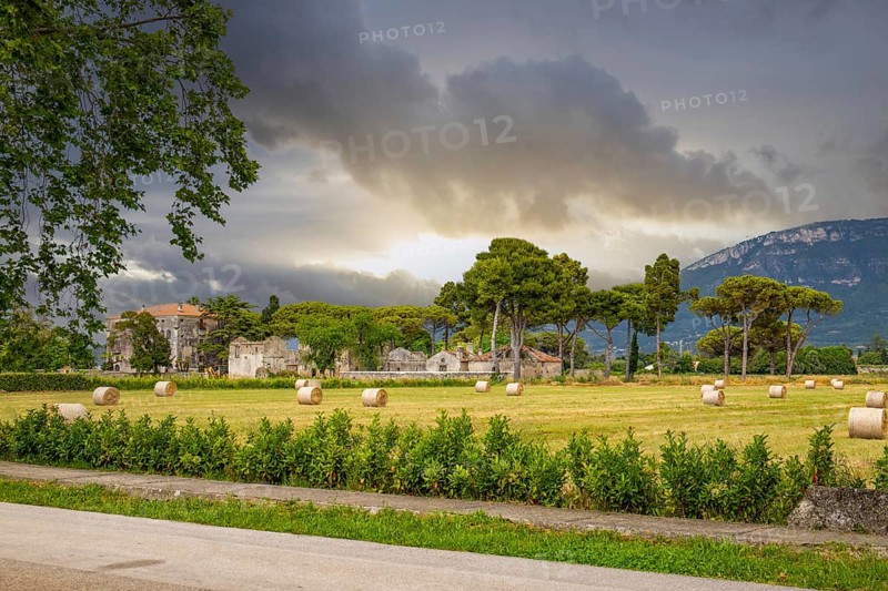 Beautiful old historical centre with ruins. Evening sunshine and the Temple of Athena in Paestum, Salerno, Italy