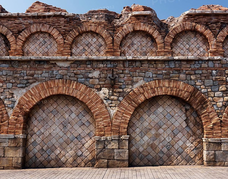 Old stone wall with brick arches antique rustic architectural texture