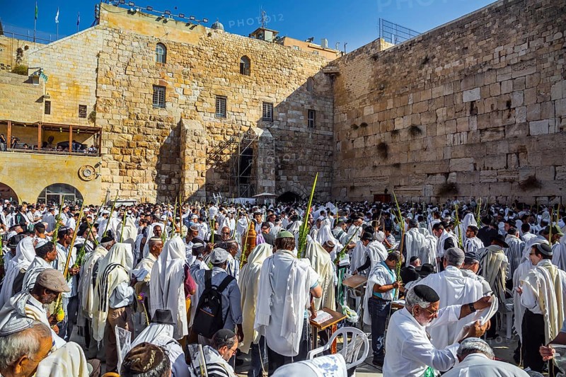 JERUSALEM, ISRAEL - SEPTEMBER 26, 2018: The blessing of the Cohanim. Jews praying wrapped in festive white Talit. Exciting festive ceremony at the Western Wall of the Temple. The concept of pilgrimage