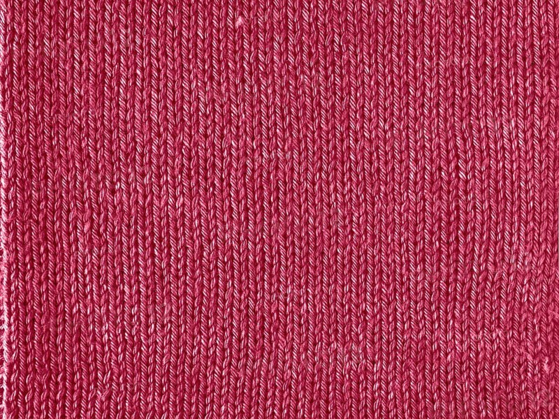 Viva Magenta color knitted Jersey as textile background. Knitted Red Magenta texture. Color of the year 2023 concept