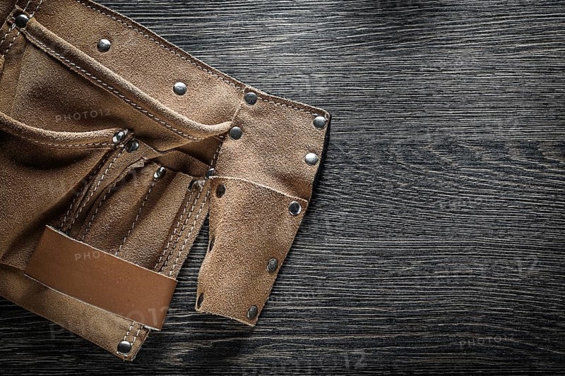 Leather tool belt on wooden board