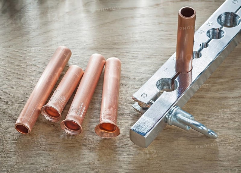 Flared pipes brake plumber on wooden board