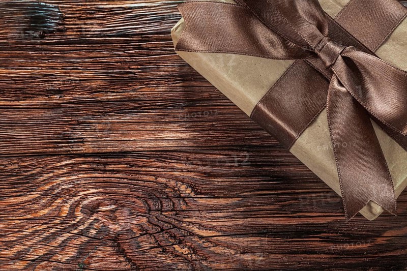 Brown gift box on vintage wooden board