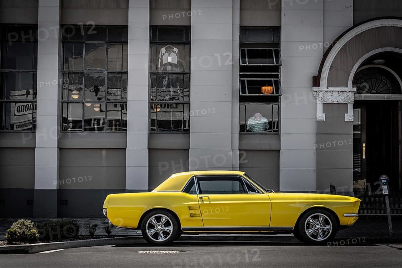 Vintage car parking in front of an Art Deco building in downtown Napier, North Island of New Zealand