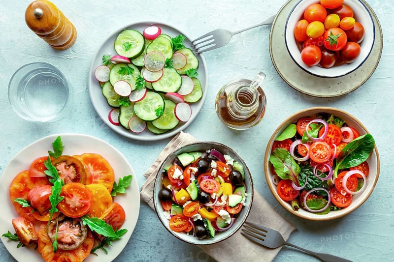 Fresh vegetarian salads, overhead flat lay shot of an assortment. Variety of plates and bowls with green vegetables. Healthy food, top shot, with olive oil, Food photography, Food photography
