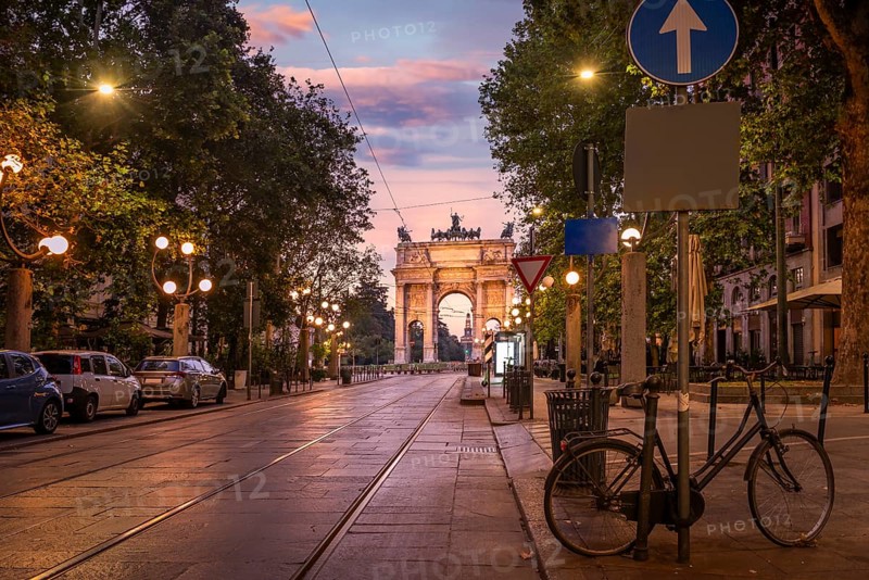 Road to the Arch of Peace and tram rails at sunrise in Milan, Italy