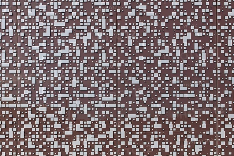 Closeup of randomly placed white tiles on painted concrete wall background texture