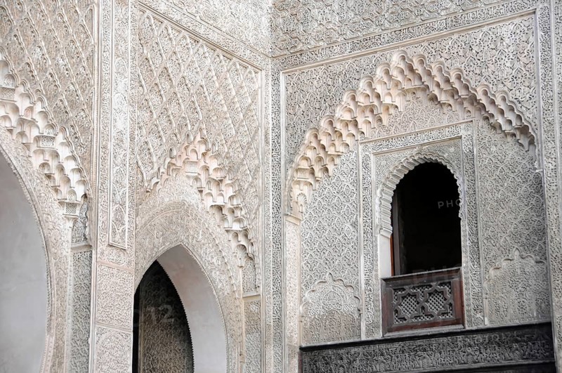 Fes, Northern Morocco, Morocco, Richly decorated wall with detailed patterns and a small window arch, Fes, Northern Morocco, Morocco