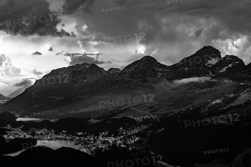 Beautiful Aerial View over Alpine Lakes and Swiss Alps and Cityscape in Sunset and Storm Clouds over St Moritz, Maloja, Grisons, Switzerland