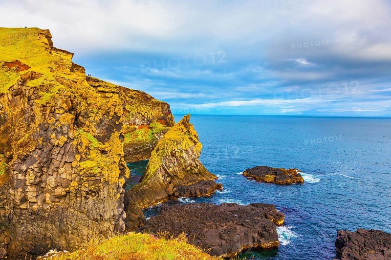 Scenic fjords on a cloudy summer day. Rocks covered with moss. Gorgeous Iceland. North sea coast
