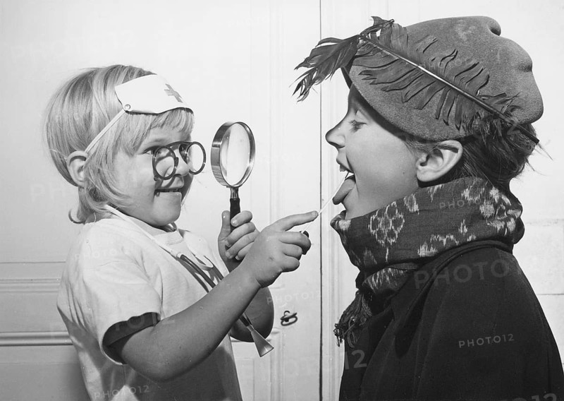 Playing doctor in the 1940s. A little girl is the doctor in this game and looks down her brothers throat like a real doctor. Sweden 1948