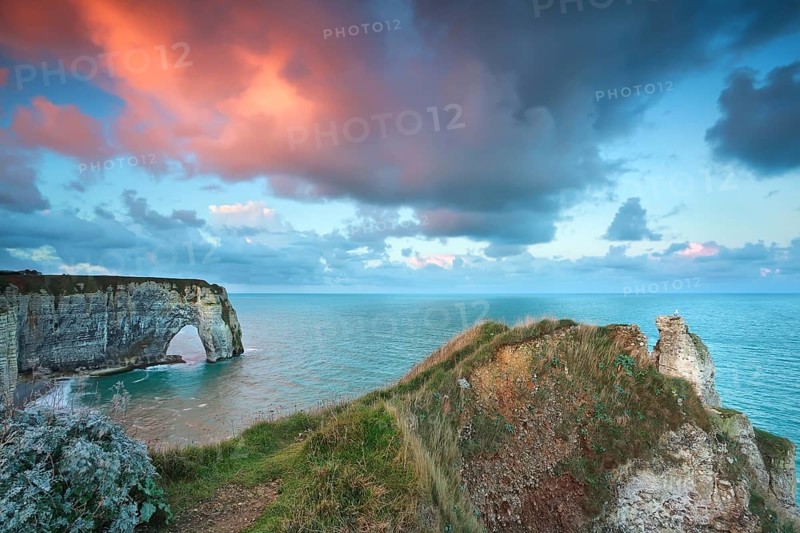 Dramatic purple sunrise over Atlantic ocean coast, Etretat, France