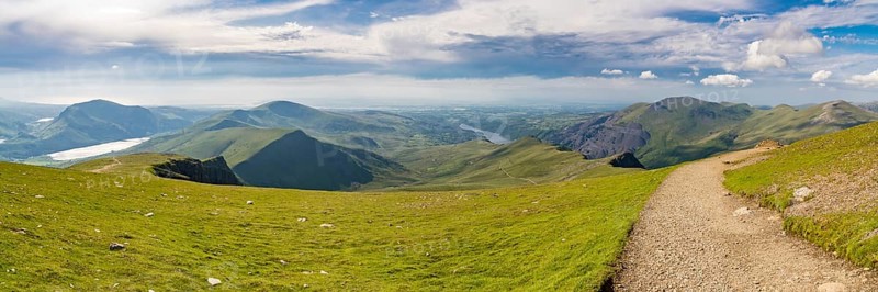 Walking down from Mount Snowdon on the Llanberis Path, Snowdonia, Gwynedd, Wales, UK, looking north towards the Clogwyn station, Llyn Padarn and Llanberis
