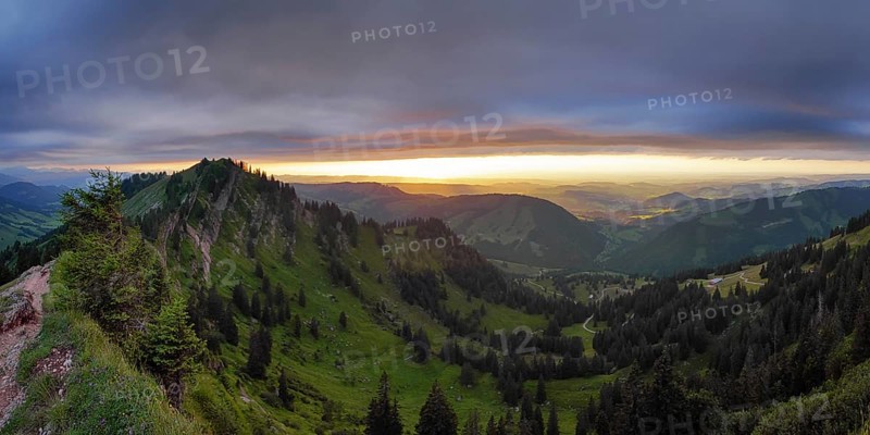 Panoramic view of a light and weather scene over the foothills of the Alps, taken from the Nagelfluhkette, Allgäu. In the centre in the background Oberstaufen and on the left the Seelekopf