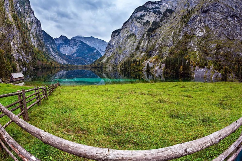 The concept of active tourism and ecotourism. Bavarian Alps. Magic blue lake Obersee and fenced path to it