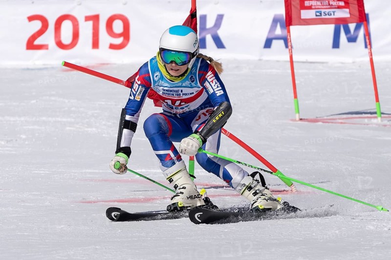 MOROZNAYA MOUNT, KAMCHATKA PENINSULA, RUSSIA, MARCH 30, 2019: Russian Federation Alpine Skiing Championship, parallel slalom. Mount skier Ksenia Fedorova Moscow skiing down mountain slope