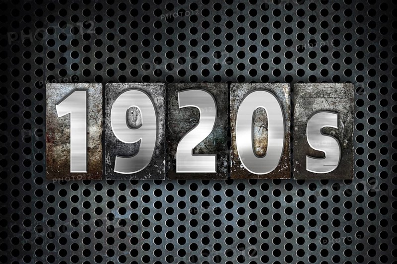The word 1920s written in vintage metal letterpress type on a black industrial grid background