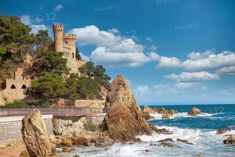 Beautiful view on Castell d'en Plaja from seaside in Lloret de Mar, Costa Brava, Spain. Sunny summer day in Lloret de Mar. Rocky coastline in spanish beach