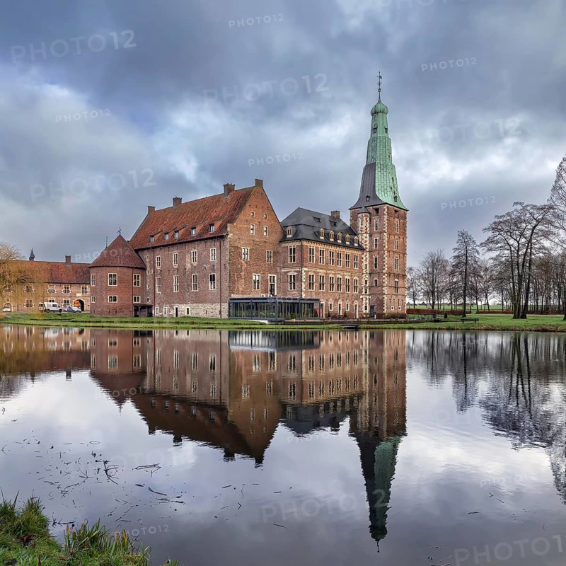 Water castle Raesfeld in Muensterland, North Rhine-Westphalia, Germany. View with reflection in the lake