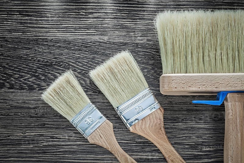 Paint brushes on wood board top view