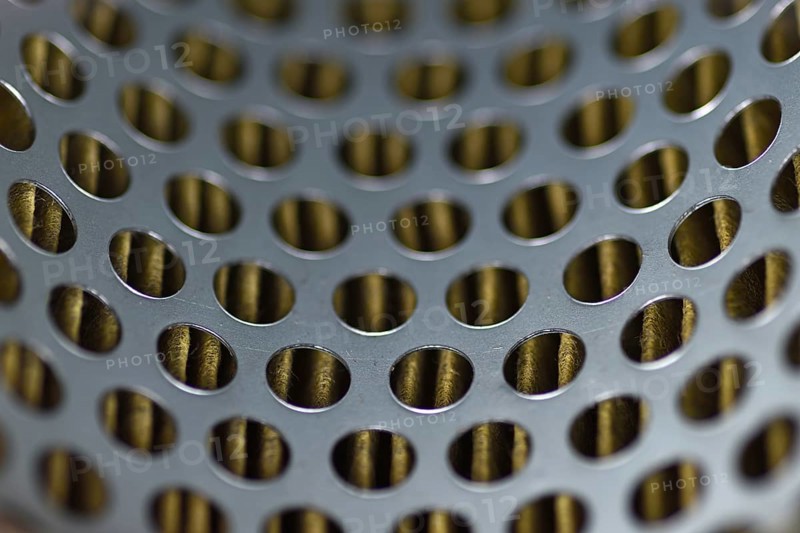 Detail of a tractor oil filter creates an industrial textured background