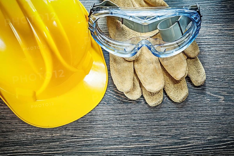Safety goggles hard hat on wooden board