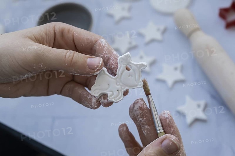Master class of painting Unrecognizable artist do it yourself air dry clay crafts for Christmas tree decor holiday. Decoration gift idea Handmade children craft. Step by step instruction of painting, pressing figures
