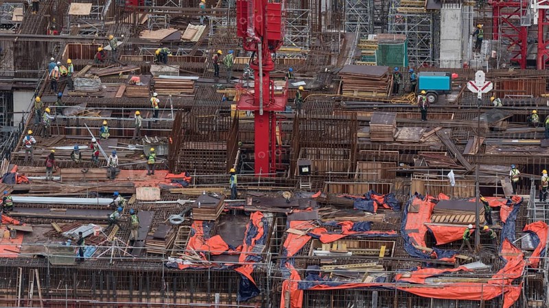 Workers busy with construction. Building a house in Kuala Lumpur, Malaysia